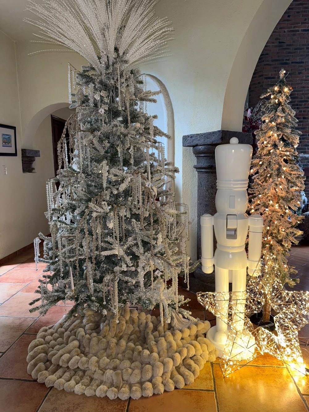 Árbol Crystal Tree con cascanueces blanco y estrellas de luz en el showroom